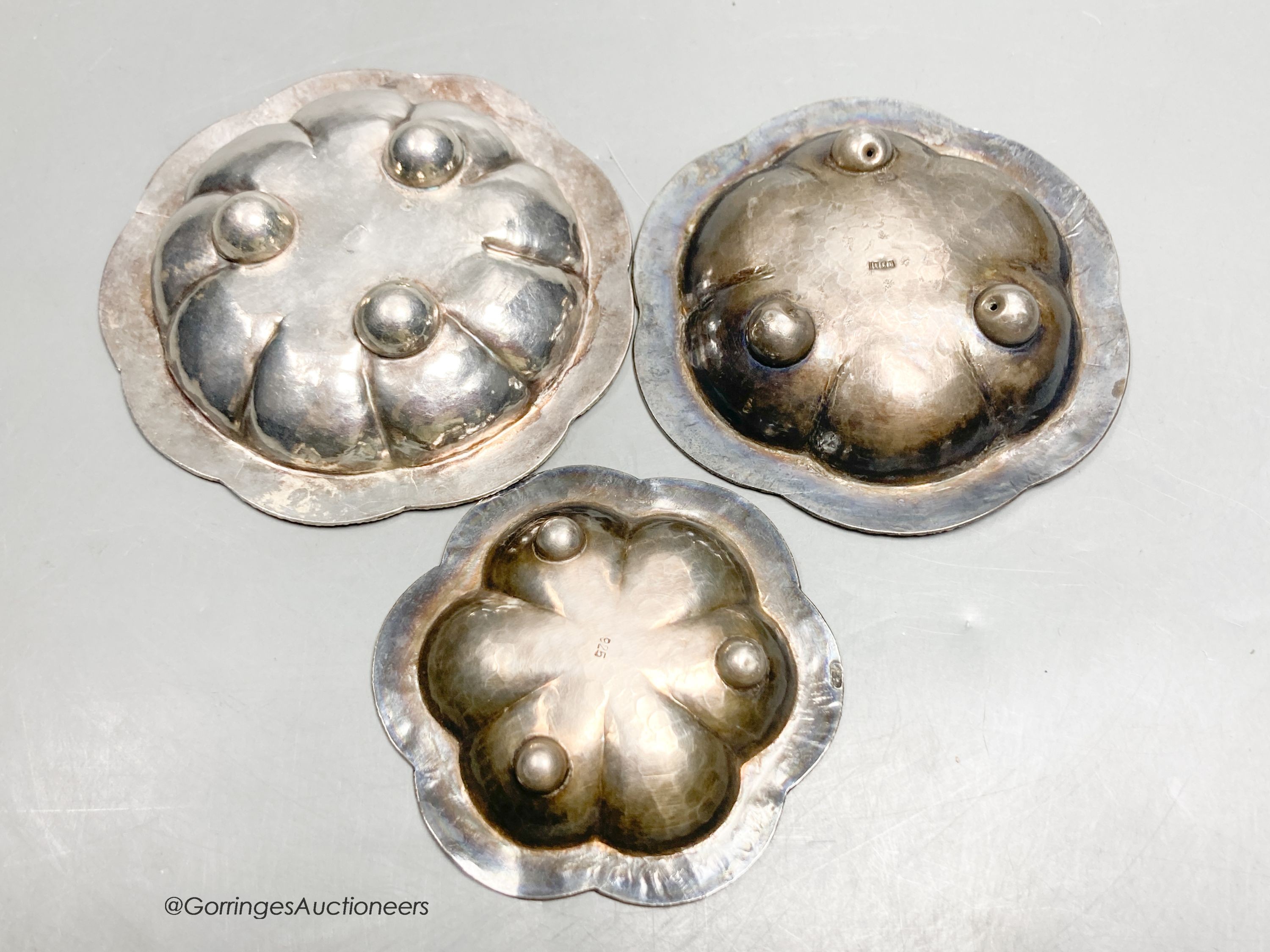 Three Persian white metal and cloisonne enamel small dishes, largest 9.6cm, gross weight 89 grams.